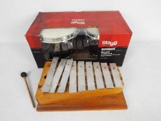A boxed pair of Stagg Bongos and a vintage glockenspiel.