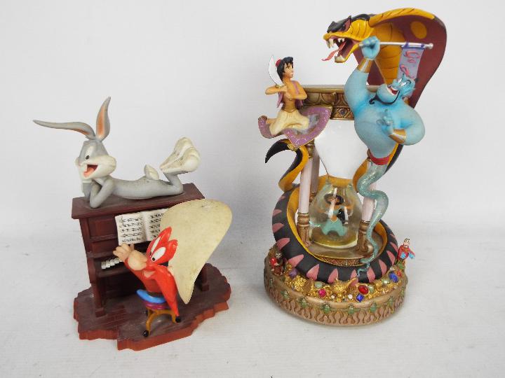 A Disney Aladdin snow globe,