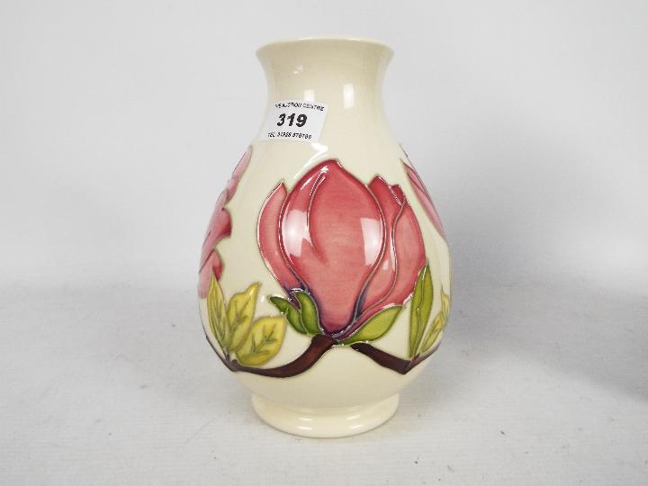 Moorcroft Pottery - a large vase of bulbous form tubelined and hand painted with pink magnolia on a - Image 3 of 5