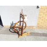 A late 19th or early 20th century spinning wheel, height 101 cm and wheel diameter 54 cm.