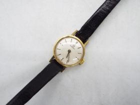 A lady's 9ct gold cased Omega wrist watch on black leather strap.