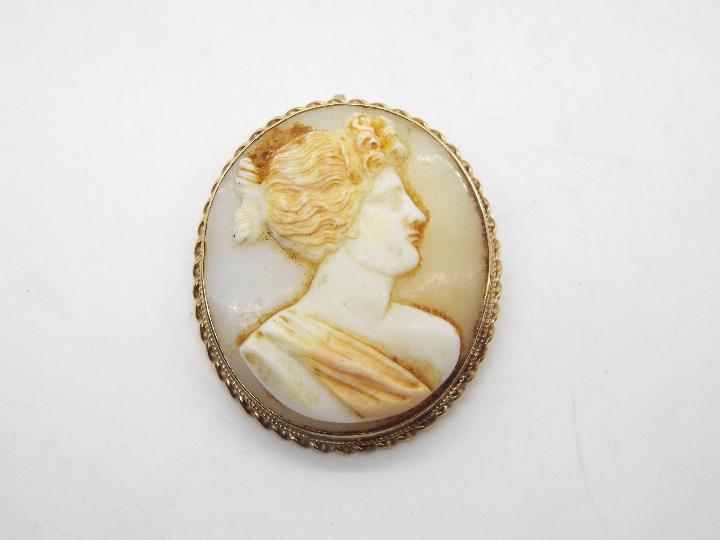 A 9ct gold mounted cameo brooch, 3.5 cm x 3 cm, approximately 10.1 grams all in.