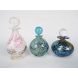Three Isle Of Wight Glass scent bottles with stoppers, largest approximately 13 cm (h).