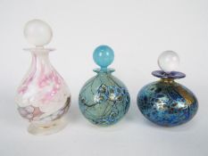 Three Isle Of Wight Glass scent bottles with stoppers, largest approximately 13 cm (h).