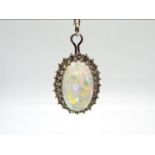 18ct gold - A white metal, opal and diamond pendant on a 56 cm white metal chain,