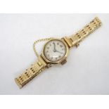 A lady's 9ct gold cased wrist watch on unmarked yellow metal bracelet with safety chain, 17.