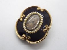 A Victorian yellow metal and enamel mourning / memorial brooch with woven hair inset,