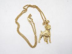 A 9ct gold pendant in the form of a boxer dog on a 9ct gold necklace, 44 cm (l), approximately 12.