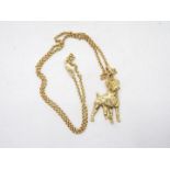 A 9ct gold pendant in the form of a boxer dog on a 9ct gold necklace, 44 cm (l), approximately 12.