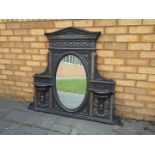 A cast iron over mantel mirror, approximately 100 cm x 118 cm.