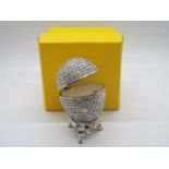 A crystal encrusted egg form trinket box with white enamel interior,