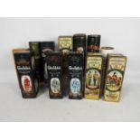 A quantity of vintage whisky presentation tins / tubes, all empty,