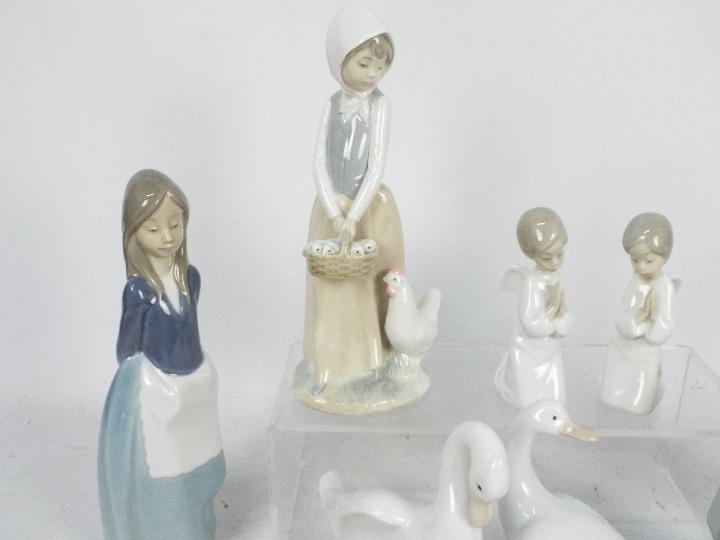 A collection of Lladro and Nao figures, largest approximately 24 cm (h). - Image 2 of 5