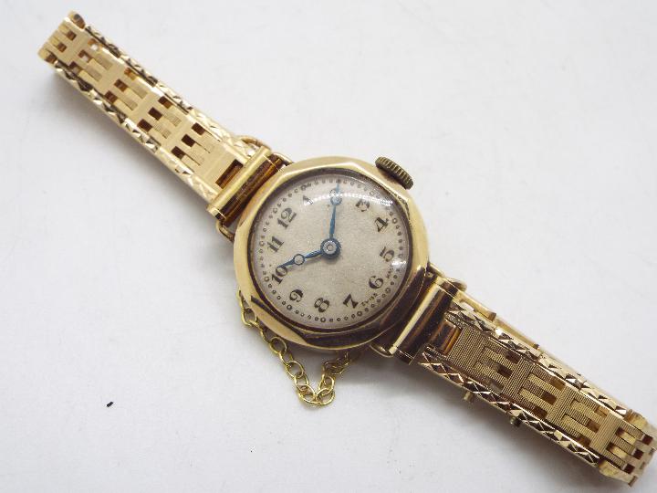 A lady's 9ct gold cased wrist watch on unmarked yellow metal bracelet with safety chain, 17. - Image 2 of 5
