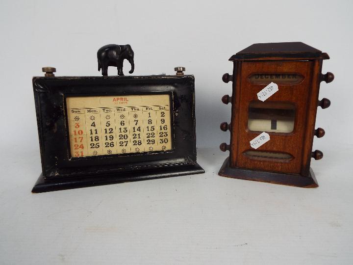 An Edwardian perpetual desk calendar and one other, largest approximately 17 cm (h).