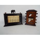 An Edwardian perpetual desk calendar and one other, largest approximately 17 cm (h).