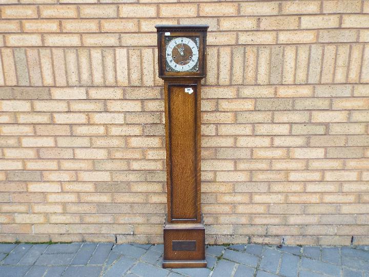 An oak cased grand daughter clock,