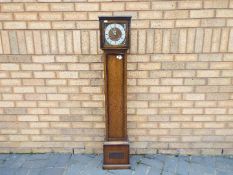 An oak cased grand daughter clock,