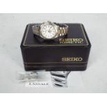 Seiko - A lady's Seiko Kinetic wrist watch, model 3M22-0800, with box and paperwork.