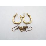 A pair of 9ct yellow gold earrings and a pair of yellow metal earrings in the form of Melpomene and
