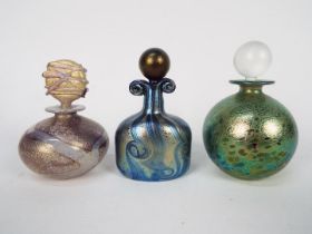 Three Isle Of Wight Glass scent bottles with stoppers, largest approximately 12 cm (h).