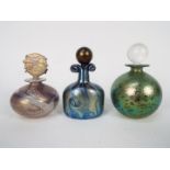 Three Isle Of Wight Glass scent bottles with stoppers, largest approximately 12 cm (h).