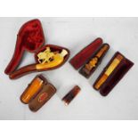 Tobacciana - A collection of cheroot holders to include a meerschaum example carved in the form of