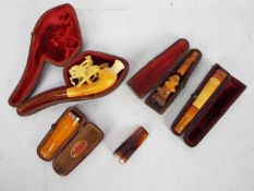 Tobacciana - A collection of cheroot holders to include a meerschaum example carved in the form of