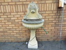 A reconstituted stone garden fountain, approximately 130 cm (h).