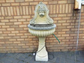 A reconstituted stone garden fountain, approximately 130 cm (h).