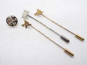 Two 9ct gold stick pins (2.6 grams) and one sterling silver example.