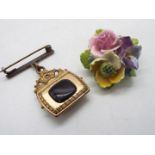 A yellow metal, mother of pearl and stone set brooch in the form of a bag and a floral brooch.