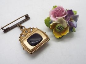 A yellow metal, mother of pearl and stone set brooch in the form of a bag and a floral brooch.