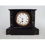 A black slate and marble mantel clock of architectural form, Roman numerals to a white dial,