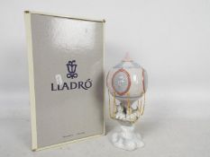 A boxed Lladro figural group entitled Through The Clouds, # 6522,