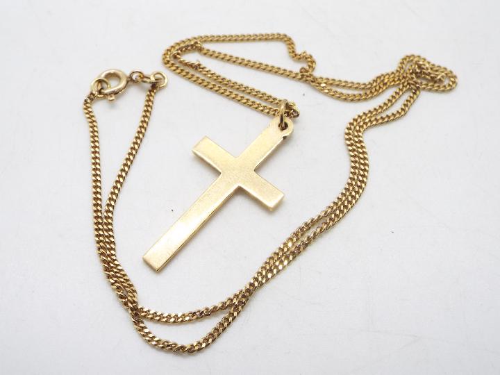 A 9ct yellow gold crucifix (2.2 grams) on a mid purity yellow metal chain stamped 585 (4.2 grams).