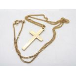 A 9ct yellow gold crucifix (2.2 grams) on a mid purity yellow metal chain stamped 585 (4.2 grams).