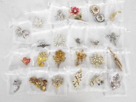A collection of costume jewellery, brooches, earrings, bracelet.
