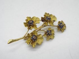 An 18ct gold stone set brooch in the form of a flowering branch,
