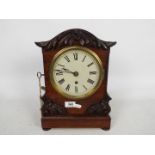 A mid-Victorian mantel clock, mahogany case with arched top and applied,