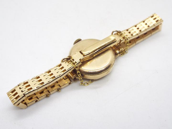 A lady's 9ct gold cased wrist watch on unmarked yellow metal bracelet with safety chain, 17. - Image 3 of 5