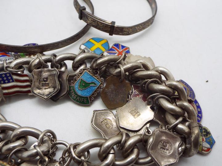 A white metal charm bracelet with a collection of charms, - Image 3 of 7