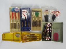 A collection of vintage darts, flights a
