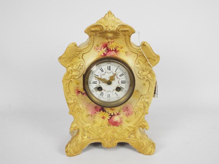 A ceramic cased mantel clock with floral