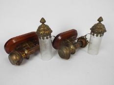 A pair of brass candle lamps bearing pla