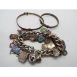 A white metal charm bracelet with a collection of charms,