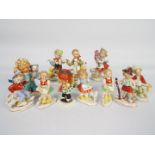 A collection of Hummel style figures and two Goebel Charlot Byj figures,