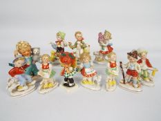 A collection of Hummel style figures and two Goebel Charlot Byj figures,