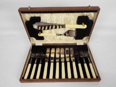 A six setting case of silver plated fish cutlery with servers.