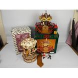 Christmas Decorations - Two boxed Christmas carousels comprising Santa's Carousel Park by Maisto